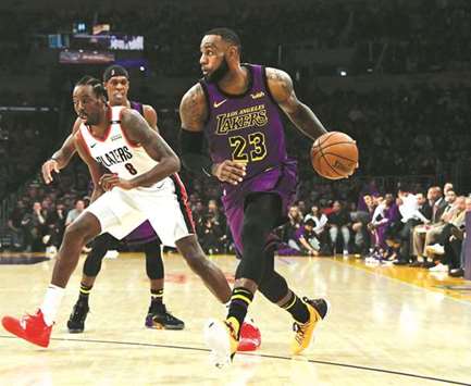Los Angeles Lakers' LeBron James (right) dribbles past Portland Trail Blazers' Al-Farouq Aminu. (USA TODAY Sports)
