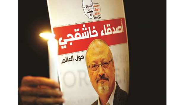 This picture taken on October 25 shows a demonstrator with a poster depicting Khashoggi, during a protest outside the Saudi Arabia consulate in Istanbul.