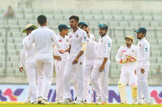 Bangladeshu2019s Mustafizur Rahman (fourth from left) celebrates with teammates after taking the wicket of Zimbabweu2019s Sean Williams (not pictured) on the fifth day of the second Test at the Sher-e-Bangla National Cricket Stadium in Dhaka, Bangladesh, yesterday. (AFP)