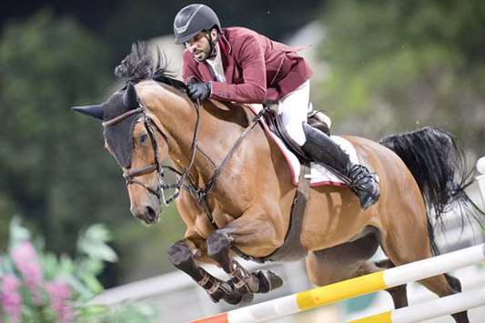 Qataru2019s Mubarak Yousuf al-Rumaihi astride Vivaldi K clears a hurdle during the Al Rayyan International Showjumping Championship at the Qatar Equestrian Federationu2019s outdoor arena yesterday. PICTURE: Lotfi Garsi