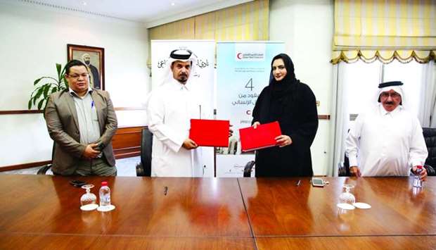 QRCS and Al-Jasrah Club officials at the MoU-signing ceremony.