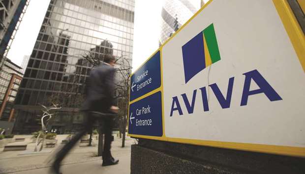 A pedestrian passes a sign outside the headquarters of Aviva in London. The enduring interest in selling off pension fund obligations among UK is likely to boost profits for some of Britainu2019s biggest insurers including Aviva, as well as smaller specialists including Just Group.