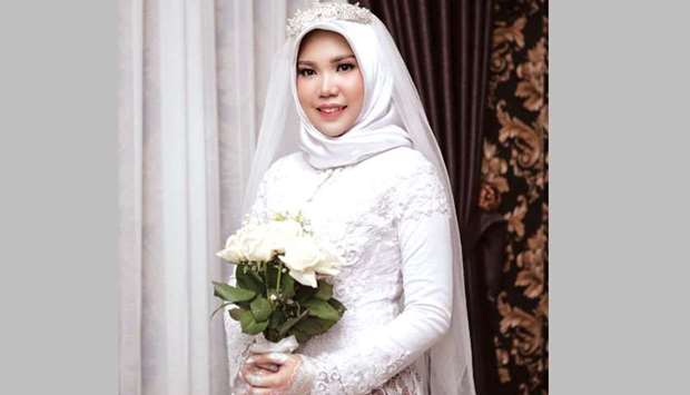 A wedding photo of the bride of a Lion Air flight JT610 victim, who carried on the celebration despite the absence of the groom, in Bangka, Bangka Belitong Province, Indonesia.