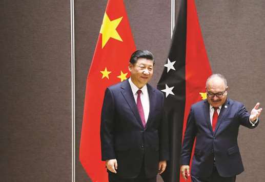 Papua New Guineau2019s Prime Minister Peter Ou2019Neill shows the way to Chinau2019s President Xi Jinping during a meeting in Port Moresby, Papua New Guinea.