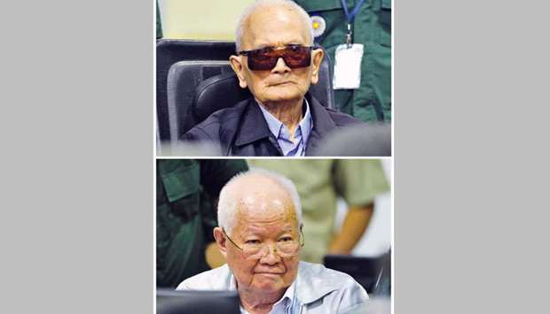 Combination photo of former Khmer Rouge leader u201cBrother Number Twou2019u2019 Nuon Chea (top) and former Khmer Rouge head of state Khieu Samphan sitting inside the courtroom during their verdict, on the outskirts of Phnom Penh yesterday.