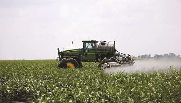File photo shows a worker use a John Deere tractor to spray a field of crops during a crop-eating armyworm invasion at a farm in Settlers, northern province of Limpopo, South Africa.