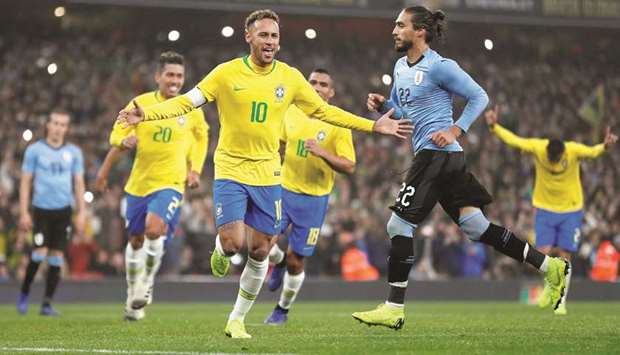 Brazilu2019s Neymar celebrates after scoring from the penalty spot in the international friendly against Uruguay at the Emirates Stadium in London on Friday night. (Reuters)