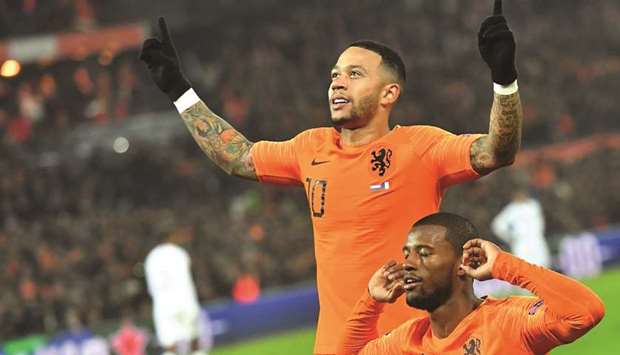 Netherlandsu2019 midfielder Georginio Wijnaldum (right) celebrates with forward Memphis Depay after scoring a goal during the UEFA Nations League football match against France at the Feijenoord stadium in Rotterdam on Friday night. (AFP)