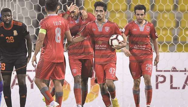Yousef El Arabi (third right) celebrates with his teammates after scoring against Umm Salal in the QSL Cup third round match yesterday.
