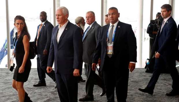US Vice President Mike Pence reacts as he walks past China's President Xi Jinping (not pictured) while leaving APEC Haus, during the APEC Summit in Port Moresby, Papua New Guinea.