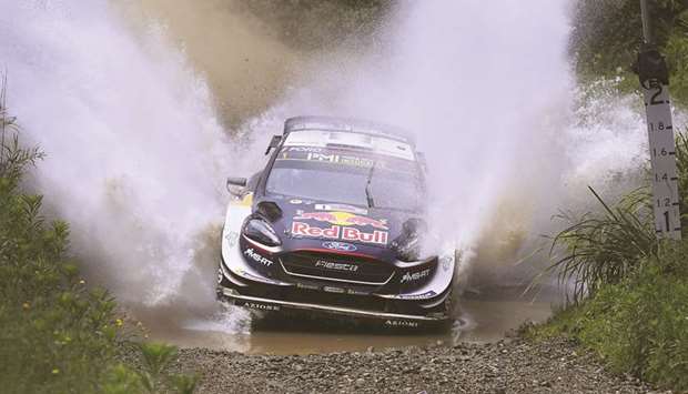 Ford driver Sebastien Ogier of France speeds through a creek on the first day of the World Rally Championship (WRC) Rally Australia near Coffs Harbour on November 16. (AFP)