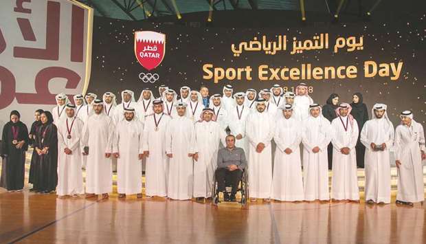 QOC President HE Sheikh Joaan bin Hamad al-Thani, QOC first vice-president HE Sheikh Saud bin Ali al-Thani, QOC second vice-president HE Dr Thani Abdulrahman al-Kuwari, and QOC Secretary-General HE Jassim al-Buenain pose with the winners at the ceremony to mark Sport Excellence Day at the Aspire Dome yesterday.