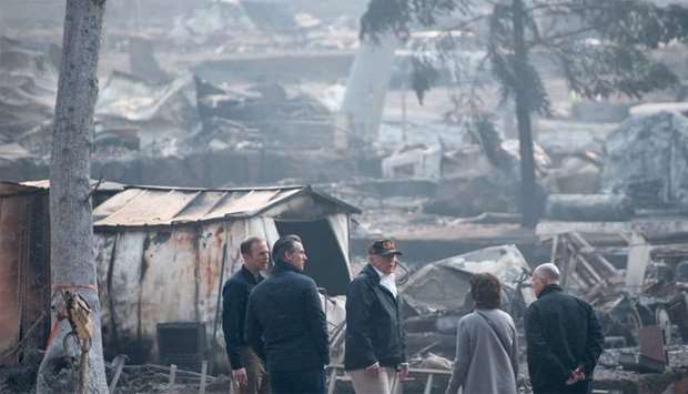 US President Donald Trump (C) speaks with Lieutenant Governor of California, Gavin Gavin Newsom (L), Paradise Mayor Jody Jones (2R), Governor of California Jerry Brown (R), and Administrator of the Federal Emergency Management Agency, Brock Long, as they view damage from the Camp fire in Paradise