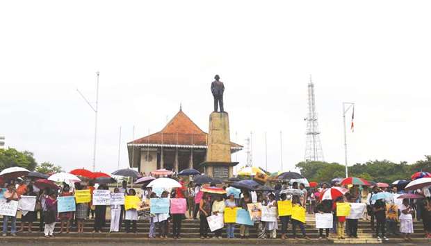 Civil activists demonstrate amid an ongoing political crisis, as rain falls in Colombo yesterday.