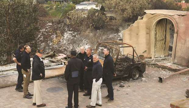 US President Donald Trump surveys homes destroyed by the Woolsey fire with California Governor-elect Gavin Newsom, first responders and California Governor Jerry Brown in Malibu, California, US, in this November 17 file picture.