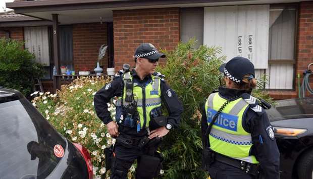 Police stand guard outside a house raided by police in the Melbourne suburb of Dallas yesterday.