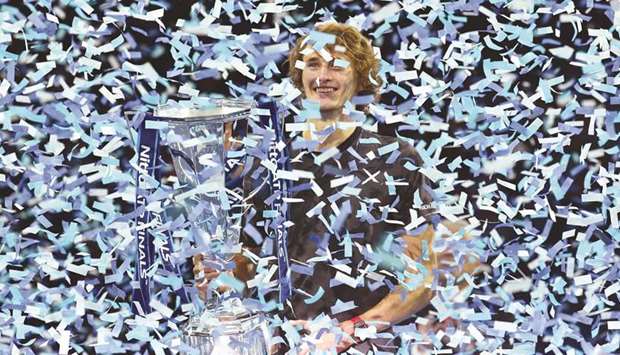 Germanyu2019s Alexander Zverev is covered in ticker tape as he holds the ATP Finals trophy after he beat Serbiau2019s Novak Djokovic in the final match on Sunday.