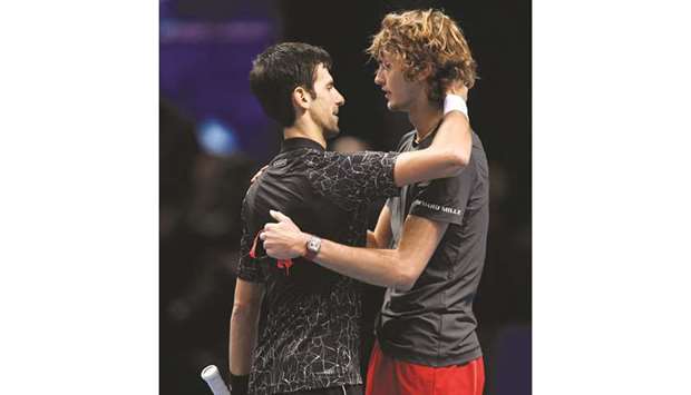 Zverev (R) hugs Djokovic after their final on Sunday.