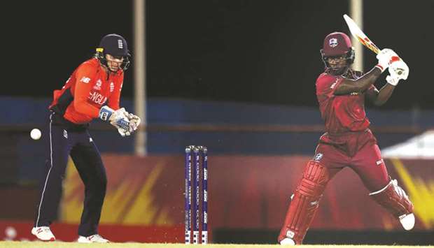 Deandra Dottin of West Indies plays a shot as England wicket-keeper Amy Jones looks on during the ICC Womenu2019s World T20 match in Gros Islet, Saint Lucia on Sunday. (ICC)