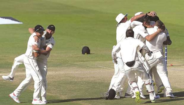 New Zealand cricketers celebrate after beating Pakistan in the first Test in Abu Dhabi yesterday. At left, man of the match Ajaz Patel with his trophy.