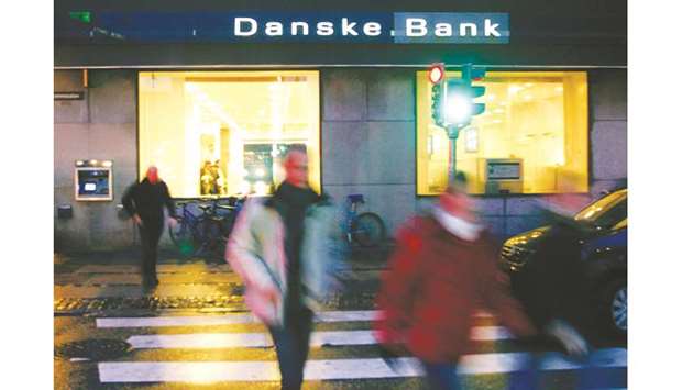 Pedestrians walk past a Danske Bank branch in Copenhagen. Payments totalling u20ac200bn ($228.5bn) made through Danske Banku2019s tiny Estonian branch between 2007 and 2015 have sparked inquiries in Denmark, Estonia, Britain and the United States in a growing global scandal.