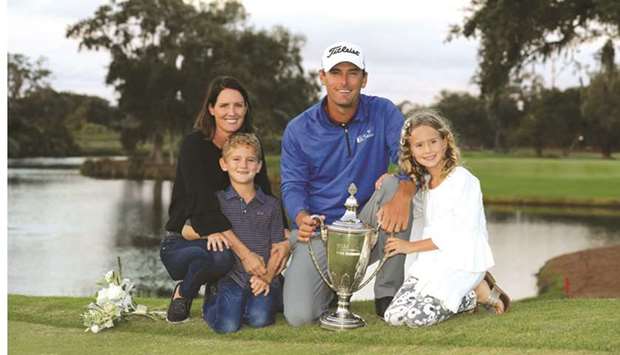 Charles Howell III of the United States poses with his wife Heather and their kids Charles and Ashley after winning the RSM Classic at the Sea Island Golf Club Seaside Course in St Simons Island, Georgia. (Getty Images/AFP)