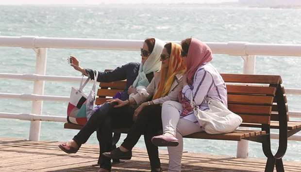 Iranian women take a selfie on the sea front in the southern resort island of Kish (file). Youth unemployment is already 25% in a country where 60% of the 80mn population is under 30.