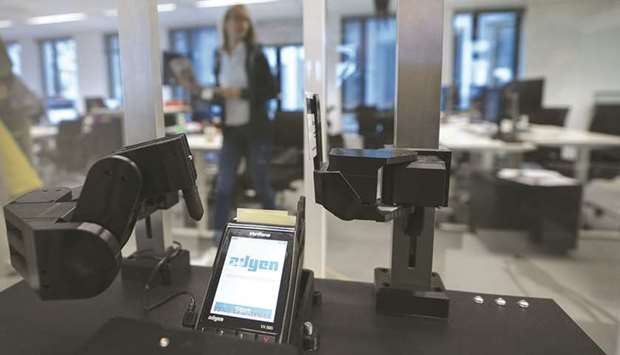 A robotic arm sits beside a contactless payment processing device, manufactured by VeriFone Systems, in the testing room inside the Adyen headquarters in Amsterdam (file). The fintech startups are focusing on improving and digitising a broad range of Islamic banking and finance services and processes and bring new, innovative solutions to the table.