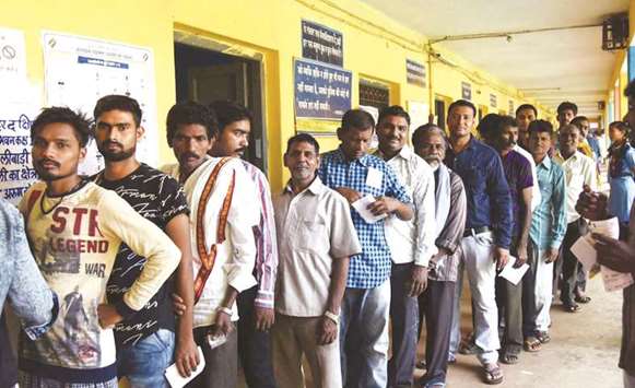 Voters wait in a queue to cast their ballots during the second and concluding phase of Chhattisgarh Assembly elections in Raipur yesterday.
