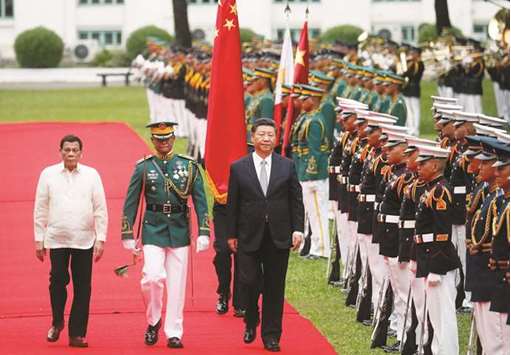 Visiting Chinese President Xi Jinping with President Rodrigo Duterte troop the line before their one on one meeting at the Malacanang presidential palace in Manila, yesterday.