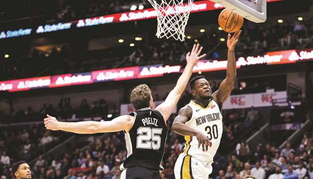 New Orleans Pelicans forward Julius Randle (right) shoots over San Antonio Spurs centre Jakob Poeltl during the NBA match on Monday. (USA TODAY Sports)