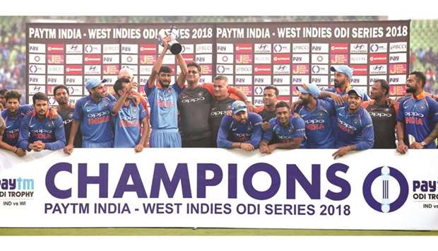 Indian cricket team players celebrate their series victory with the trophy after their win in the fifth one-day international against West Indies at the Greenfield International Stadium in Thiruvananthapuram, India, yesterday. (AFP)