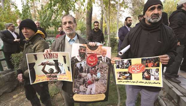 Iranians carry placards as they demonstrate in front of the UN office in Tehran yesterday, in support of the Yemen people.