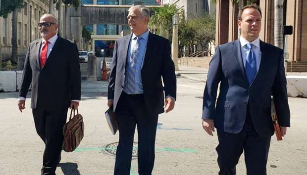 (L-R) Attorneys Jamie Benjamin, Daniel Aaronson and Peter Patanzo representing Cesar Sayoc, who's accused of mailing pipe bombs to prominent critics of U.S. President Donald Trump, walk outside the Federal Court building in Miami, Florida.
