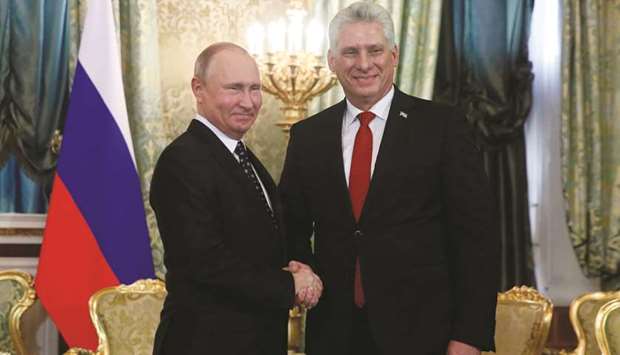 Russian President Vladimir Putin welcomes Cuban President Miguel Diaz-Canel during their meeting at the Kremlin in Moscow yesterday.