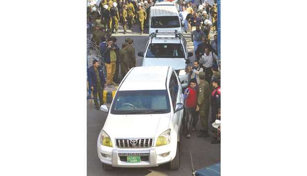A security convoy transporting arrested opposition leader Shehbaz Sharif leaves the corruption court premises following a case hearing in Lahore yesterday.