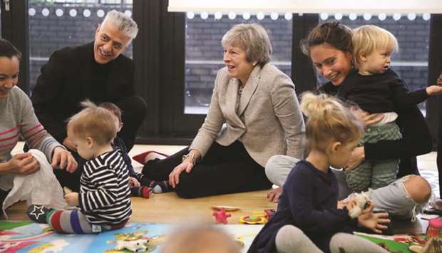 Prime Minister Theresa May joins a parent and baby group during a visit to the Kentish Town health centre in north London yesterday.