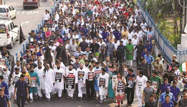 Trinamool Congress (TMC) workers stage a protest march in Kolkata yesterday against the killing of five persons by militants in Tinsukia, Assam.