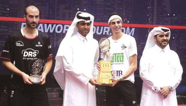 Qatar Classic winner Ali Farag of Egypt receives his trophy from Nasser al-Kheleifi, President of the Qatar Tennis and Squash Federation. Runner-up Simon Rosner and  tournament director and federation Secretary-General Tariq Zainal are also seen. At bottom, Farag celebrates after winning the final point. PICTURES: Jayan Orma