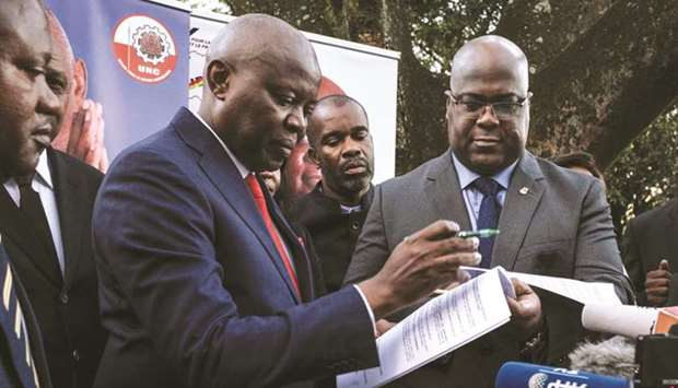 Democratic Republic of Congo (DRC) opposition leader of the UNC party Vital Kamerhe (left) and Felix Tshisekedi of the UDF party sign documents as they announce Tshisekedi will run for president in Decemberu2019s elections with Kamerhe as his running mate during a press conference in Nairobi, yesterday.