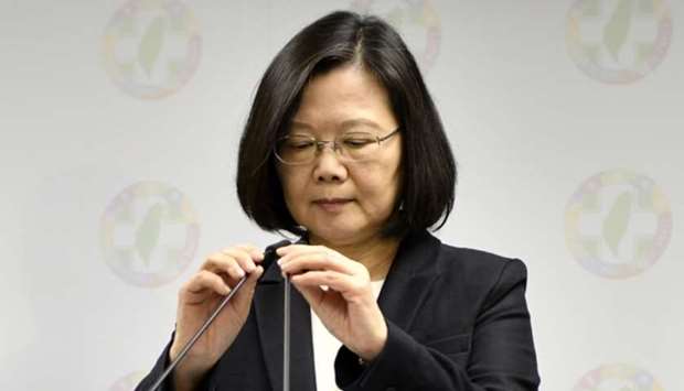 Taiwan President Tsai Ing-wen (C) adjusts a microphone during a press conference at the headquarter of ruling Democratic Progressive Party (DPP) in Taipei