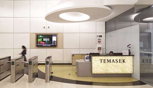 Signage for Temasek Holdings is displayed in the lobby at the companyu2019s headquarters in Singapore. The state investment firm is setting up new groups to explore opportunities in artificial intelligence and blockchain technologies.
