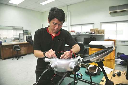 Singapore Technologies Aerospaceu2019s assistant principal engineer Calvin Tan assembling a DrN 15 drone at its workshop in Singapore.