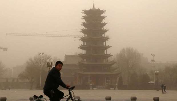 A cyclist riding in a sandstorm in Zhangye, in China's northwestern Gansu province