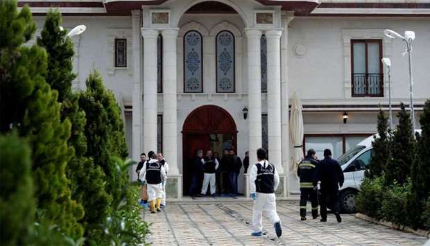 Turkish police forensic experts and plainclothes police officers stand at the entrance of a villa in the Samanli village of the Termal district in the northwestern province of Yalova