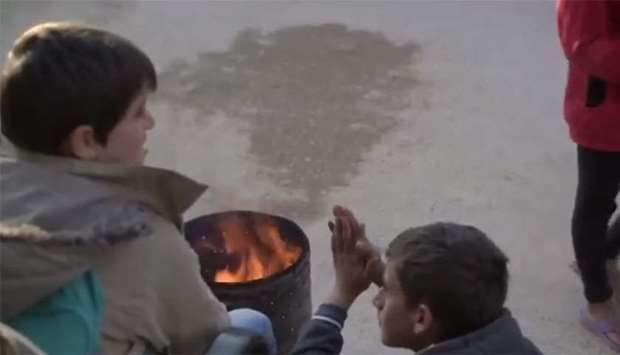 Palestine children try to keep themselves warm by lighting a fire. Image grab from a video posted on UNICEF's Twitter page