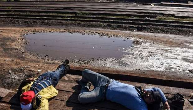 Migrants sleep next to railway tracks near the town of Bujanovac, Serbia. 2015 October 26 file picture.  AFP