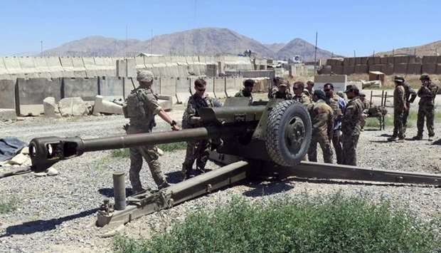 US military advisers work with Afghan soldiers at an artillery position on an Afghan National Army base in Maidan Wardak province, Afghanistan. August 6, 2018 file photo