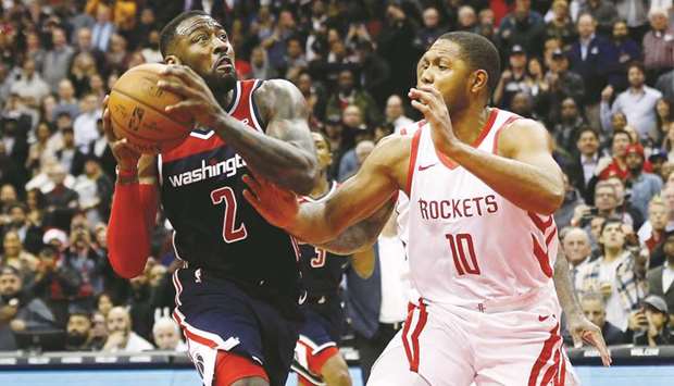 Washington Wizards guard John Wall drives to the basket as Houston Rockets guard Eric Gordon defends in the fourth quarter at Capital One Arena. The Wizards won 135-131 in overtime. PICTURE: USA TODAY Sports