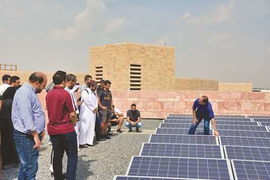 Tamuq students look at the solar panels on the roof of the branch campusu2019s building in Education City.